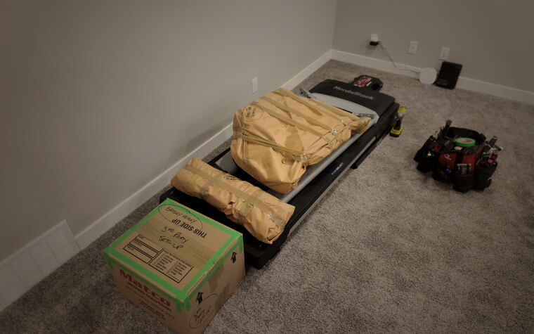 Disassembled home-gym equipment wrapped and packed for transport