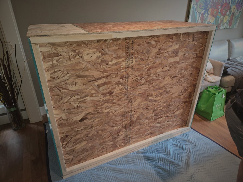 The finished sealed crate holding the television, built in the client's living room