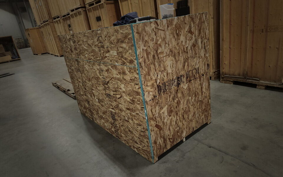 A sealed OSB shipping crate built for freight, staged in the warehouse before pickup.